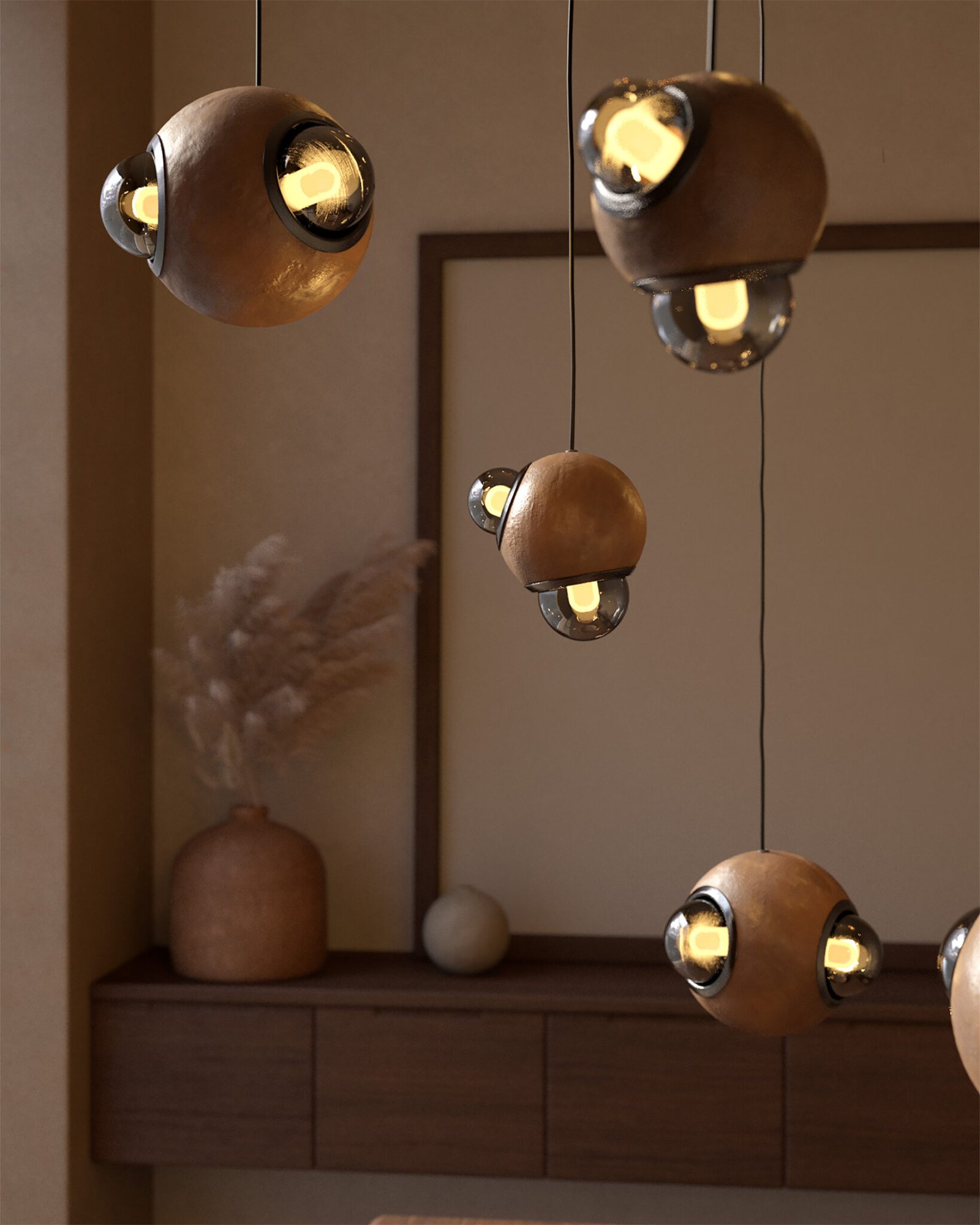 Lámparas HUMO esferas de barro moteado con difusores de vidrio ahumado y detalle de aluminio anodizado color negro diseñadas por Bandido Studio en cocina.