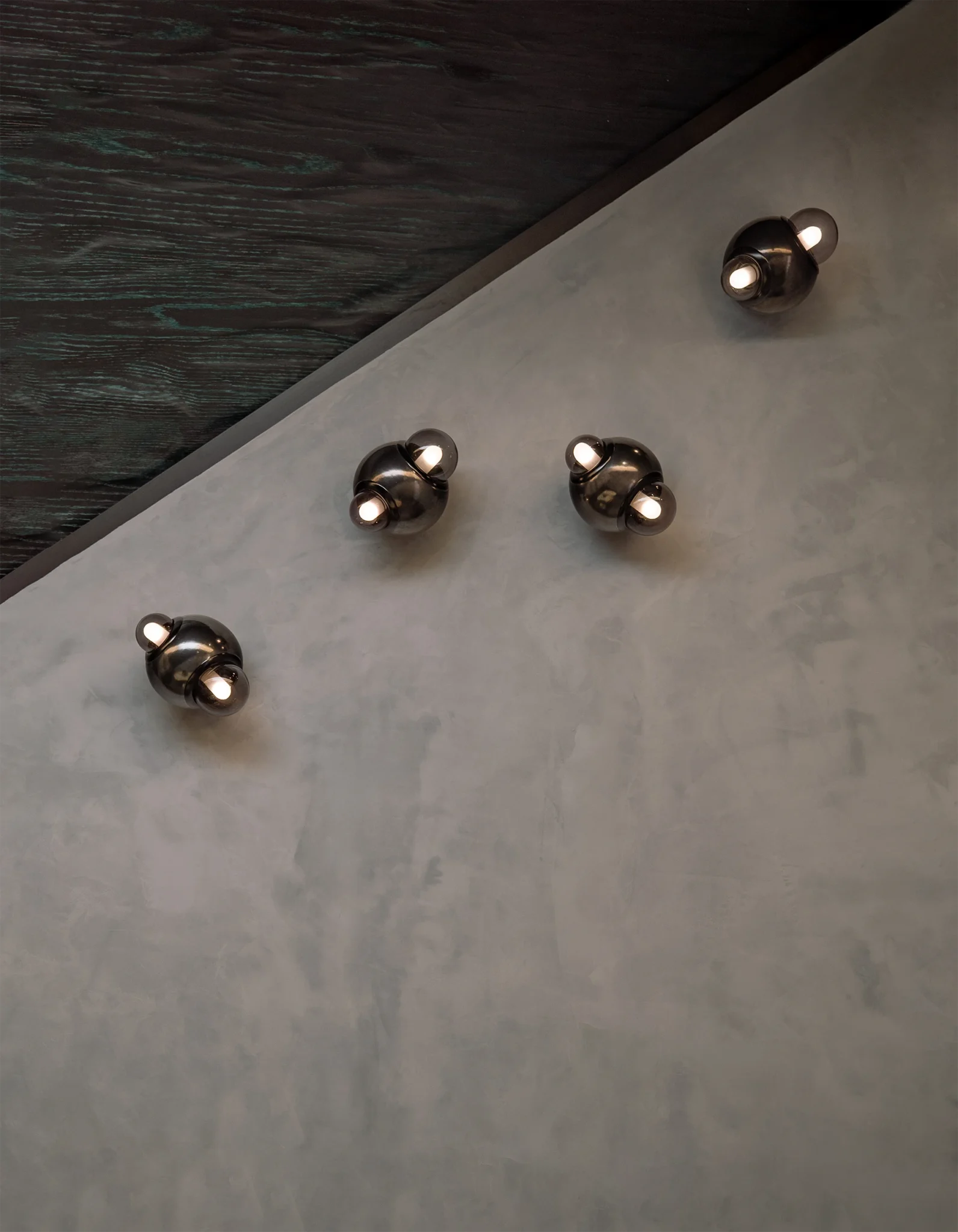 Set of HUMO wall lamps in black clay and smoked diffusers designed by Bandido Studio in Santuario Espejo, a space designed by Grande Studio & Primitivo Taller at Design House 2025