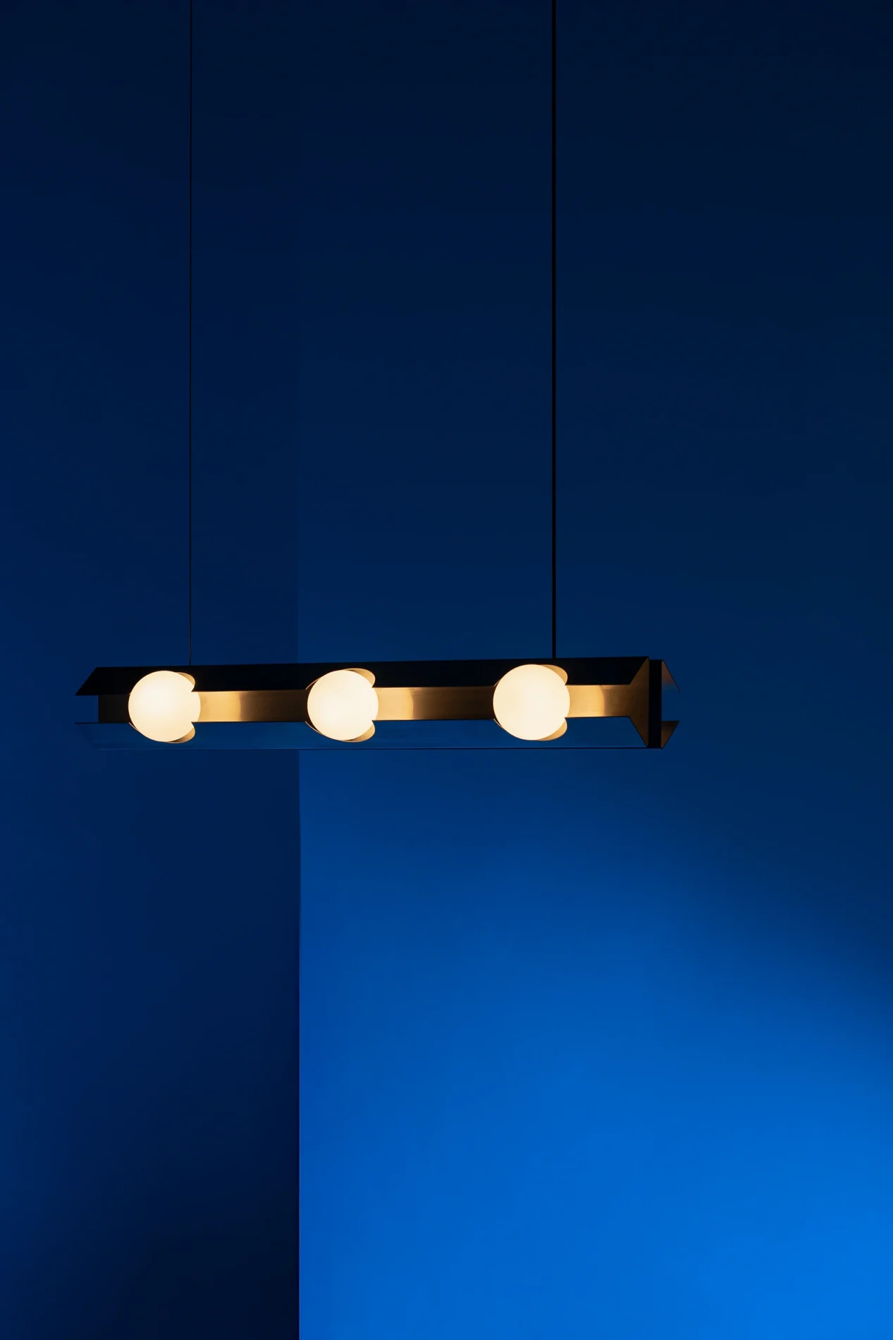 Luminaria colgante FLUX 70 diseñada por Bandido hecha de acero inoxidable con difusores esféricos de vidrio